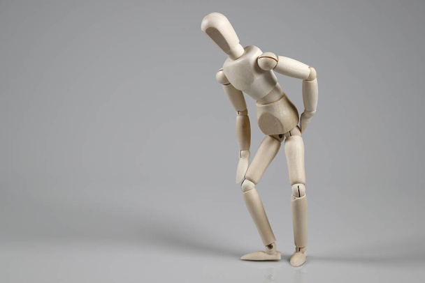 A wooden mannequin isolated on gray background. - 写真・画像