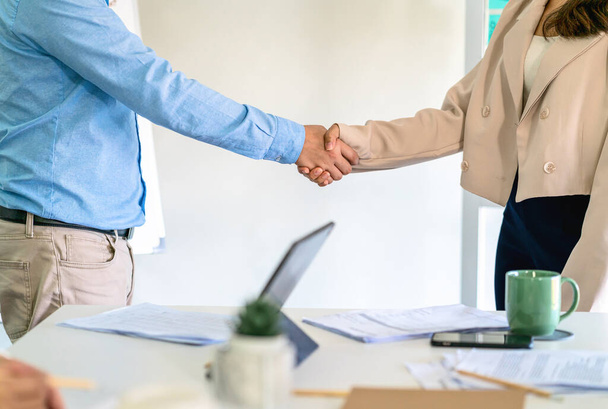 Closeup handshake of asian partner businessman and businesswoman in modern office after deal the agreement together, business Negotiate and accomplishment, Small business owner and stockholder concept - Photo, Image