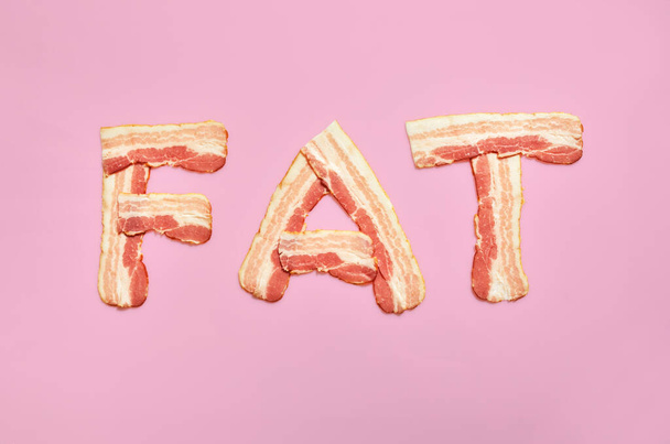 Fat word made of bacon isolated on pink - Zdjęcie, obraz