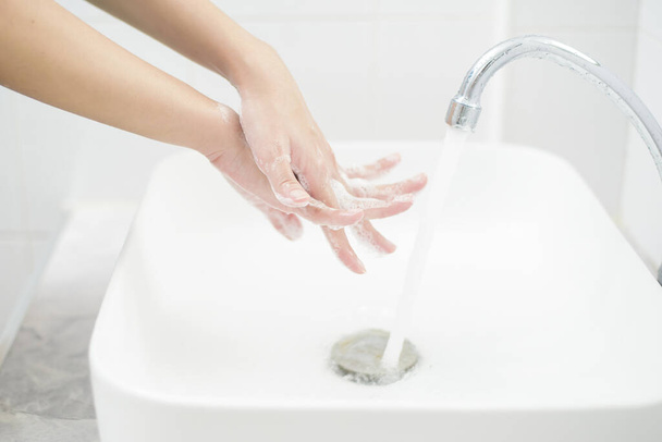 A woman is washing hands  - Photo, Image