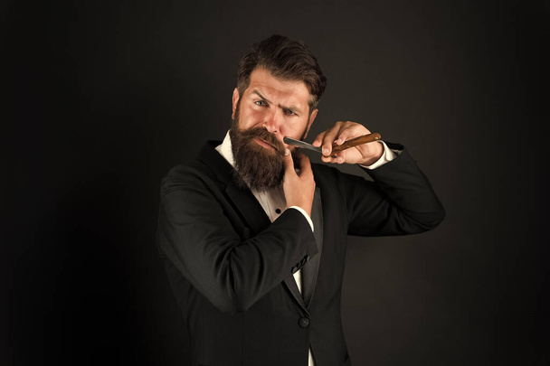 Beard is over. Brutal businessman shave with razor. Bearded man with classic shave. Shave barbershop. Shave and haircut - 写真・画像