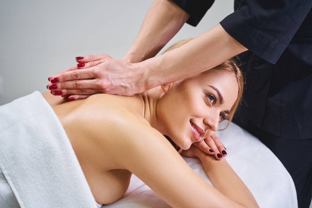 Happy lady during back massage stock photo - Foto, immagini