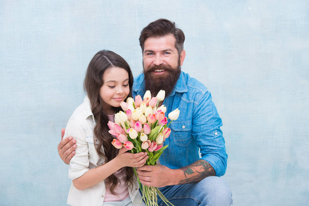 She worth all treasures. Tender tulips for daughter. Man tulips bouquet. Father giving tulips girl. Dad with flowers. Birthday celebration. International womens day. Flower shop. Family tradition - Foto, imagen