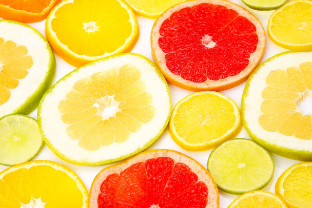 cortar pedaços de frutas cítricas diferentes no fundo branco
 - Foto, Imagem
