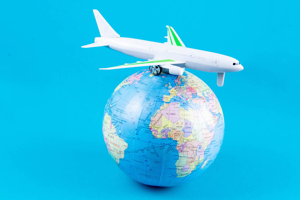 Plastic toy plane on the globe. Flight travel concept. Travel by airplane. Takeoff and landing of the aircraft. Return home from flight. empty Copy space. - Фото, зображення