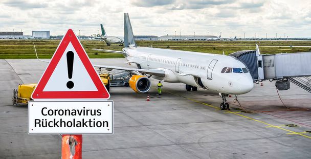 Wirus Corona zwraca sygnał ostrzegawczy z samolotem w języku niemieckim - Zdjęcie, obraz