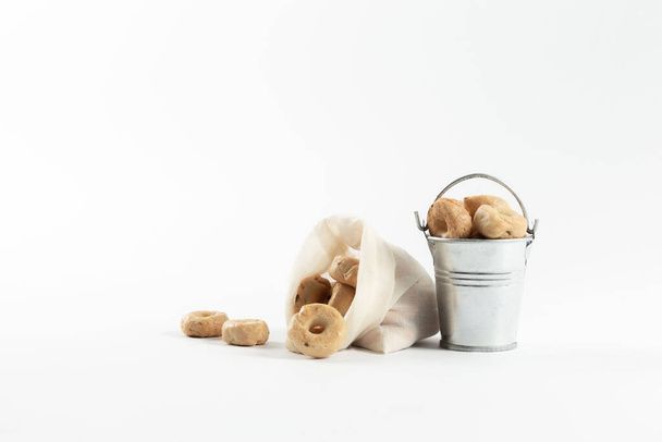 Small cooked snacks in an iron retro bucket. Proper nutrition. On white background. - 写真・画像