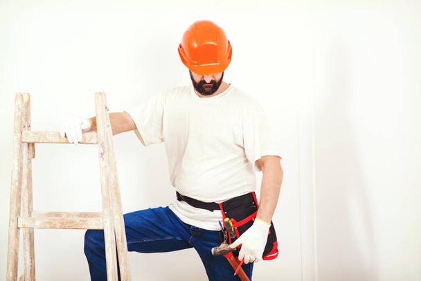 Home renovations service. Painter man at work. Handyman with a tool belt. Skillful and professional painter. Painters work. Construction and renovation. Bearded painter in hard hat. - Foto, Imagem
