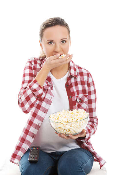 Young casual woman eating popcorn. - Foto, immagini