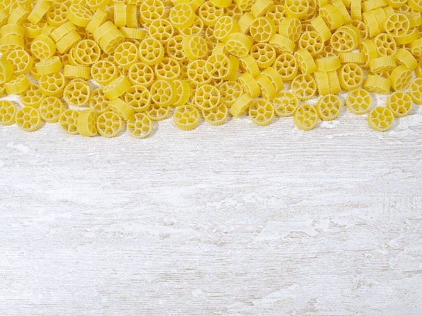 close-up wheel-shaped pasta. there is a place to add notes - 写真・画像