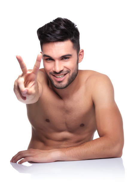 γυμνός νεαρός, κάνοντας το σήμα της νίκης - Φωτογραφία, εικόνα