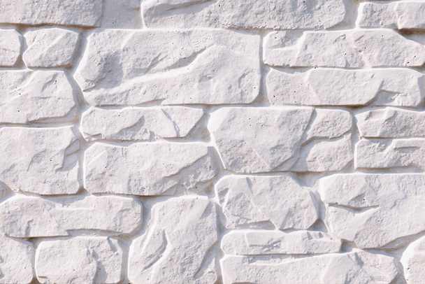 Closeup white house wall element revetted with a natural stone. White background.  - Photo, Image