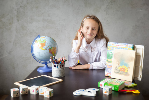 School girl in a uniform studying from home. back to school concept. Place for text. Distance learning from home, homeschooling during quarantine, stay at home concept - Foto, Imagem
