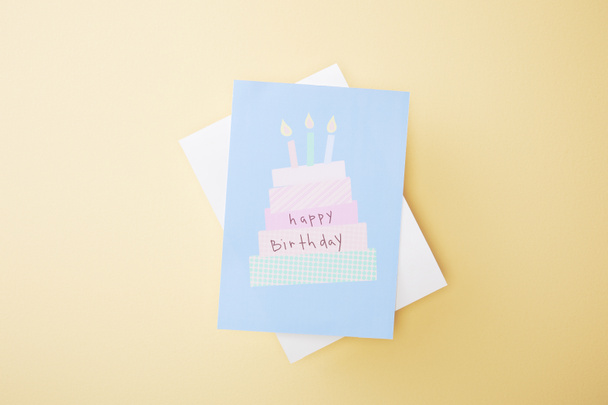 top view of festive happy birthday greeting card on beige background - 写真・画像