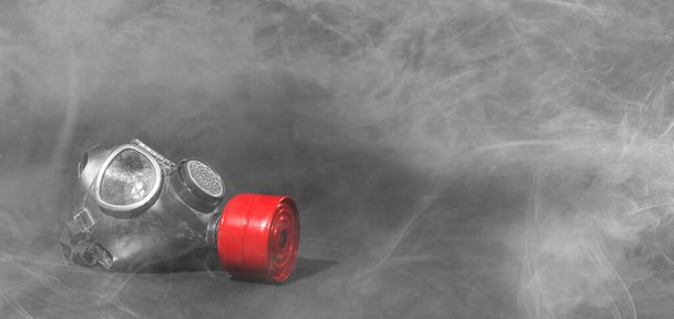 Vintage gasmask isolated on black background - Smoke in the room - Red filter - Photo, Image