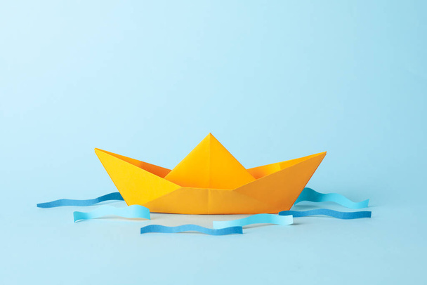 Paper boat and waves on blue background, space for text - Photo, image