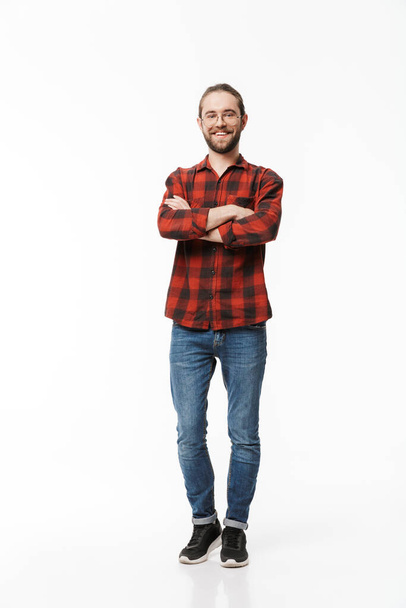 Image of a happy young handsome bearded man posing isolated over white wall background. - Foto, afbeelding