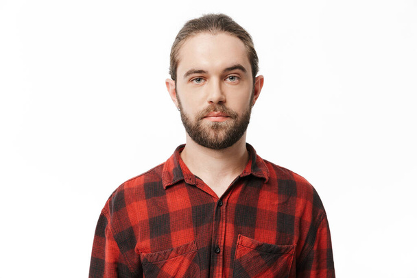 Picture of a serious young handsome bearded man posing isolated over white wall background. - Foto, Imagem