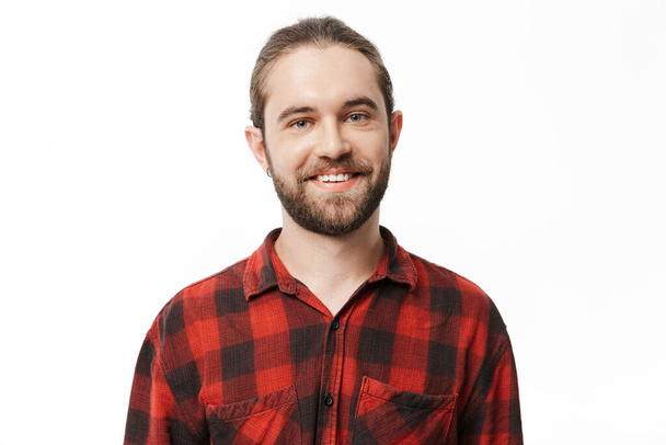 Image of a smiling young handsome bearded man posing isolated over white wall background. - 写真・画像