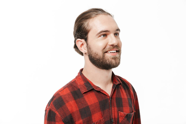 Image of a cheery positive young handsome bearded man posing isolated over white wall background. - Foto, Imagem