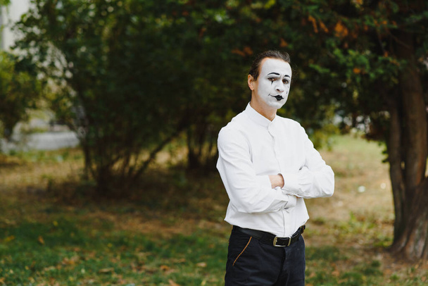 young Funny mime shows something. - 写真・画像