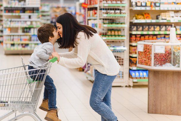 Mother with son at a grocery store - Photo, Image