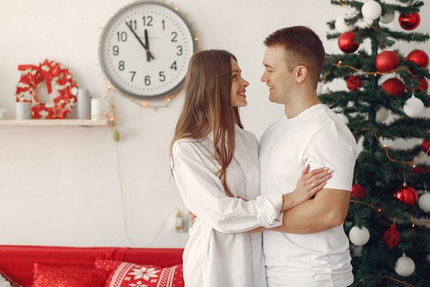 Elegant couple at home near christmas tree - Zdjęcie, obraz
