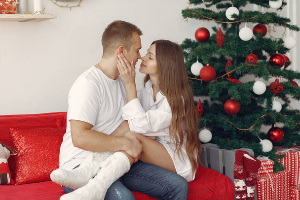 Elegant couple at home near christmas tree - Valokuva, kuva