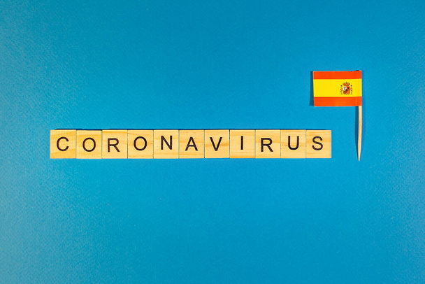 Abstract virus strain model of MERS-Cov or middle East respiratory syndrome coronavirus and Novel coronavirus 2019-nCoV with text on blue background. Country flag Spain - Valokuva, kuva