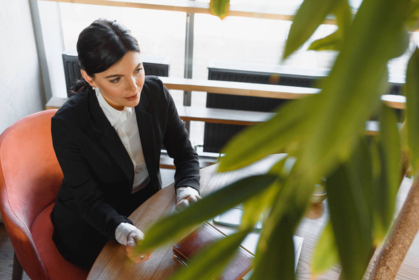 Portrait of an elegant businesswoman using tablet PC in a bright modern office - 写真・画像