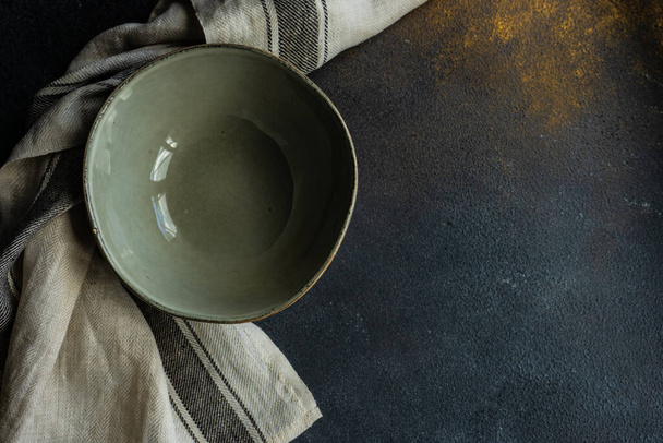 Rustic table setting with ceramic bowl on stone background with copy space - 写真・画像