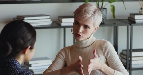 Confident female insurer consulting client about insurance benefits at meeting - Video