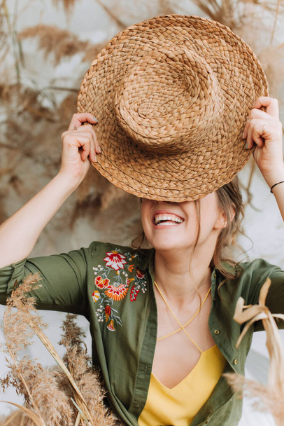 laugh girl smile joy beautifully holds straw hat tourist season vacation - Foto, afbeelding