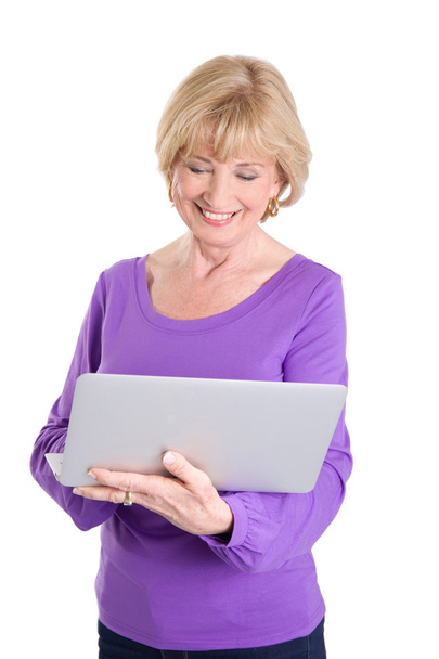 Mature woman using laptop - 写真・画像