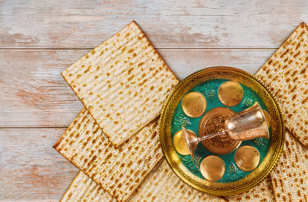 Matzoh passover jewish holiday celebration with matzoh of seder with text in hebrew egg, bone, herbs, karpas, chazeret and charoset. - Photo, Image