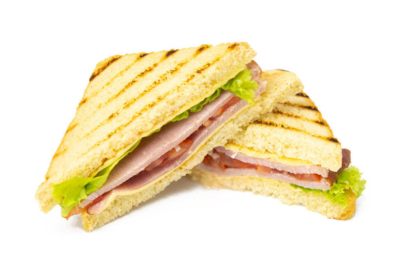 Sandwich mit Schinken, Käse, Tomaten, Salat und geröstetem Brot. Vorderseite isoliert auf weißem Hintergrund. - Foto, Bild