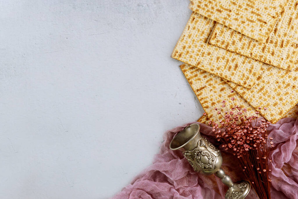 Matzah bread with kosher kiddush and flowers. Jewish Passover holiday concept. - Photo, Image