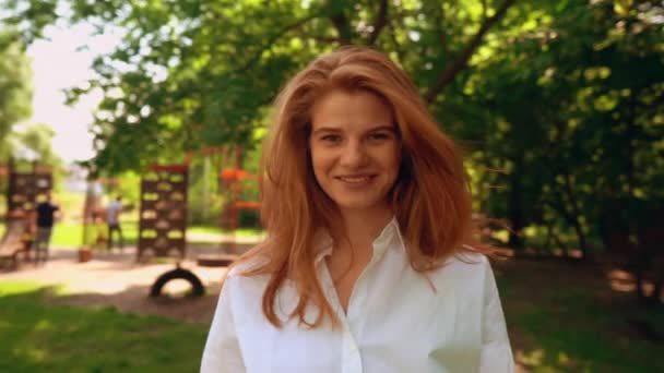 portrait young cheerful woman in park - Felvétel, videó