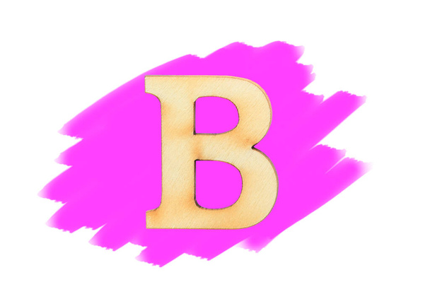 Alphabet letter wooden font on painted color pink isolated on white background. English flat wood character B. - Foto, Imagen