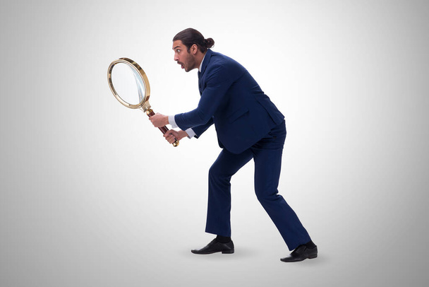 Businessman with giant magnifying glass - Photo, Image