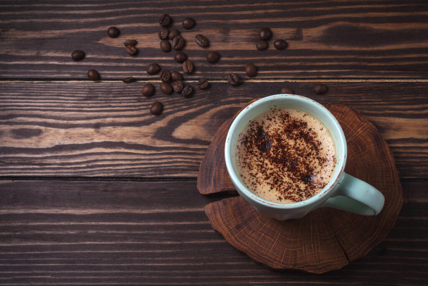 Cup with coffee on a rural wooden tabletop. Latte or cappuccino with chocolate sprinkles. copy space. top view - Photo, Image