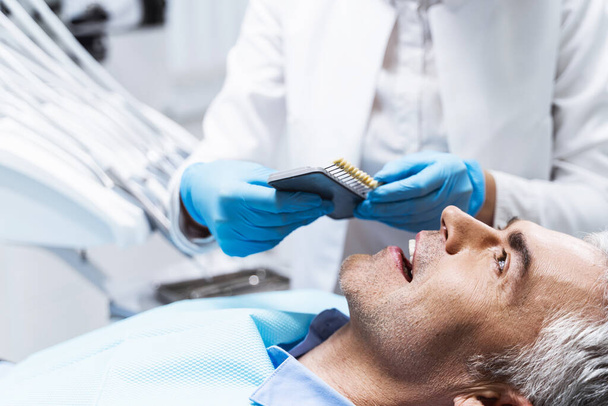 Cheerful man in dentist office stock photo - Foto, afbeelding