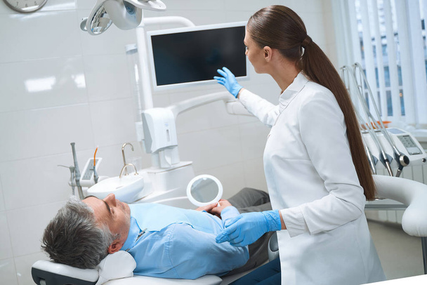 Female dentist consulting male in office stock photo - Photo, image