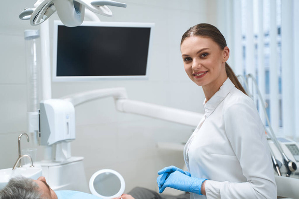 Happy female dentist during appointment stock photo - Foto, Imagen