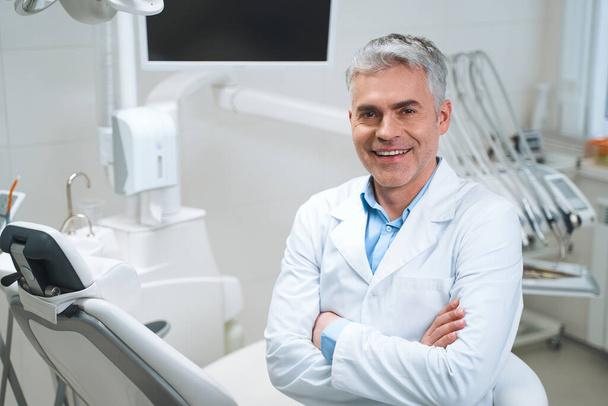 Cheerful dentist in his office stock photo - Photo, image