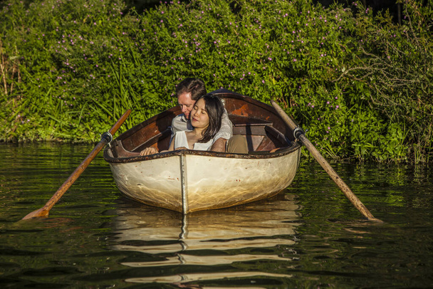 Romantic couple in a boat on honeymoon travel enjoying summer holidays.  - Фото, зображення