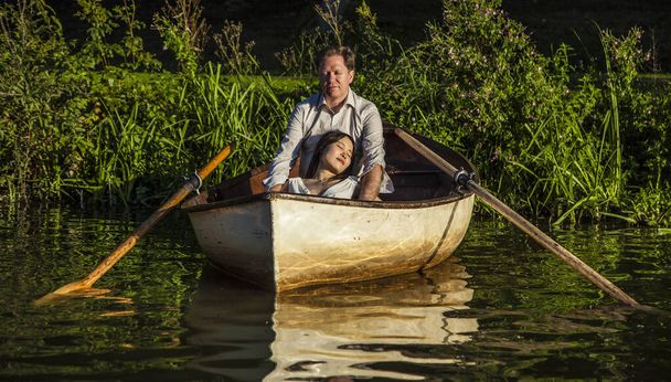 Romantic couple in a boat on honeymoon travel enjoying summer holidays.  - Photo, Image