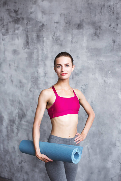Beautiful woman with yoga mat. Workout. - Фото, изображение