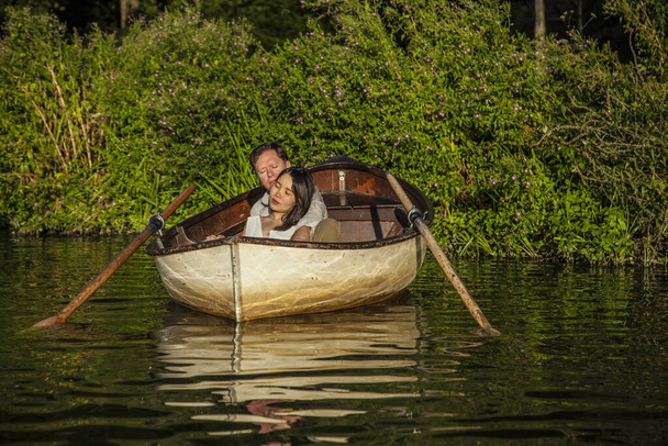 Romantic couple in a boat on honeymoon travel enjoying summer holidays.  - Foto, Bild