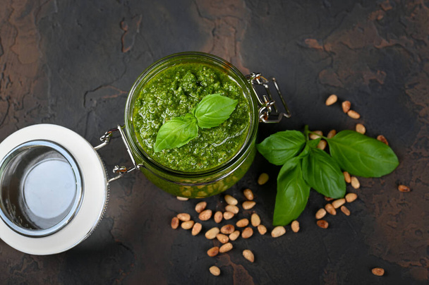 Homemade pesto sauce fresh Basil and nuts on dark background. A copy of the places. Soft focus. - Foto, Bild